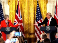 British Prime Minister Theresa May and U.S. President Donald Trump gesture towards each other during their joint news conference at the White House in Washington, U.S., January 27, 2017. REUTERS/Kevin Lamarque